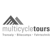 A scenic view of cyclists on a road surrounded by nature